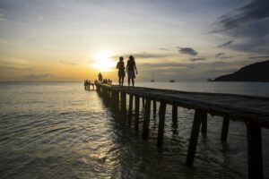 Tourists on pier watching at sunset, Koh Rong, Koh Kong province, Cambodia