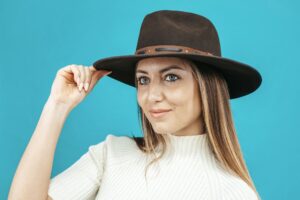 Young woman wearing cowboy hat at studio